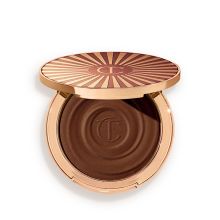 Product image of Charlotte Tilbury BEAUTIFUL SKIN SUN-KISSED GLOW BRONZER 4 Deep ბრონზერი